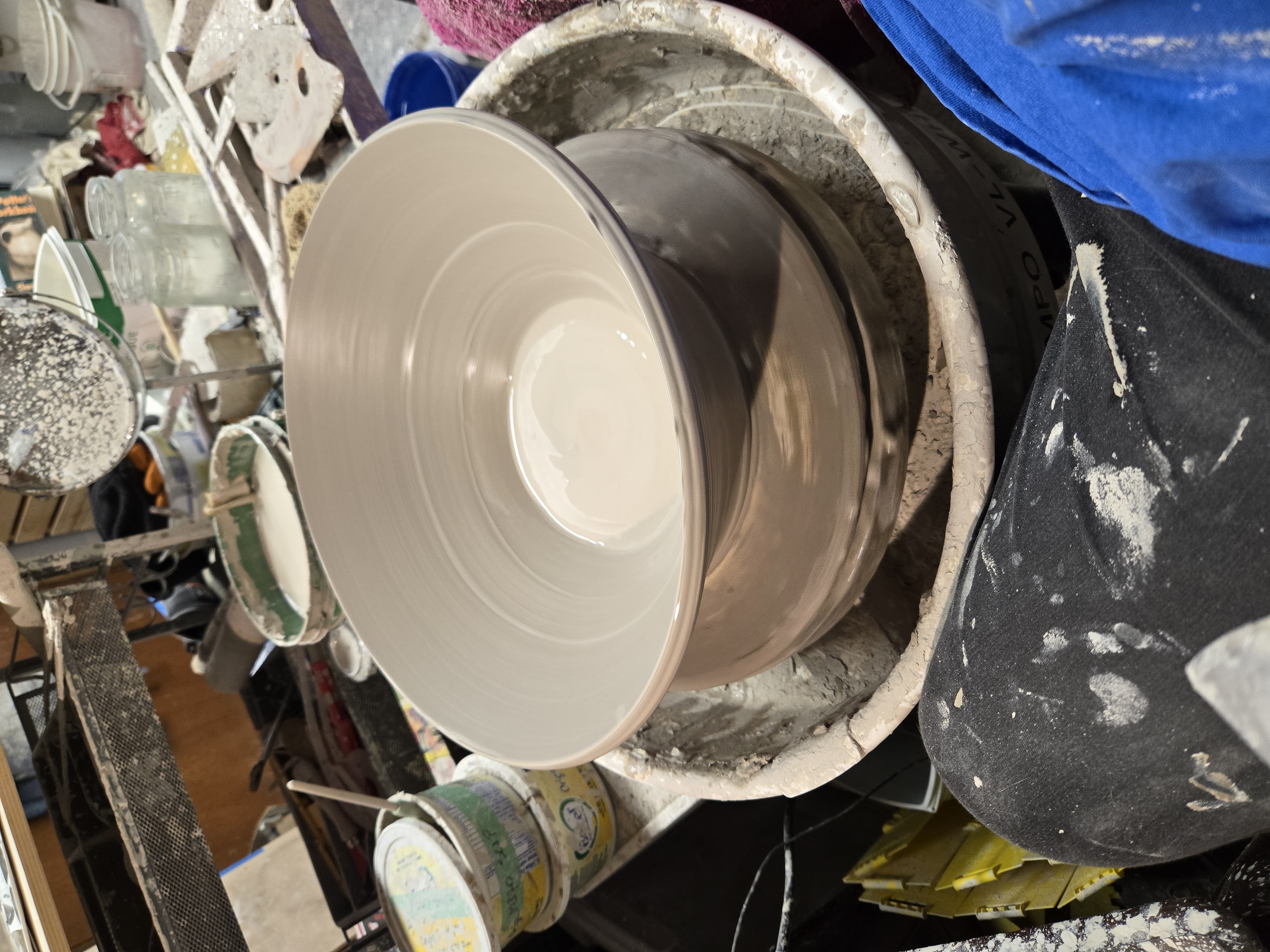 A large bowl just thrown on the wheel.