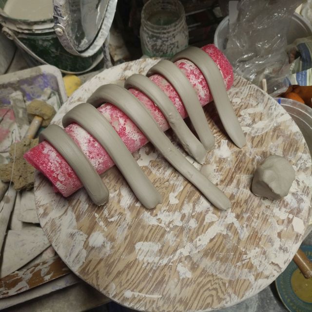 Handles waiting to be attached to mugs.