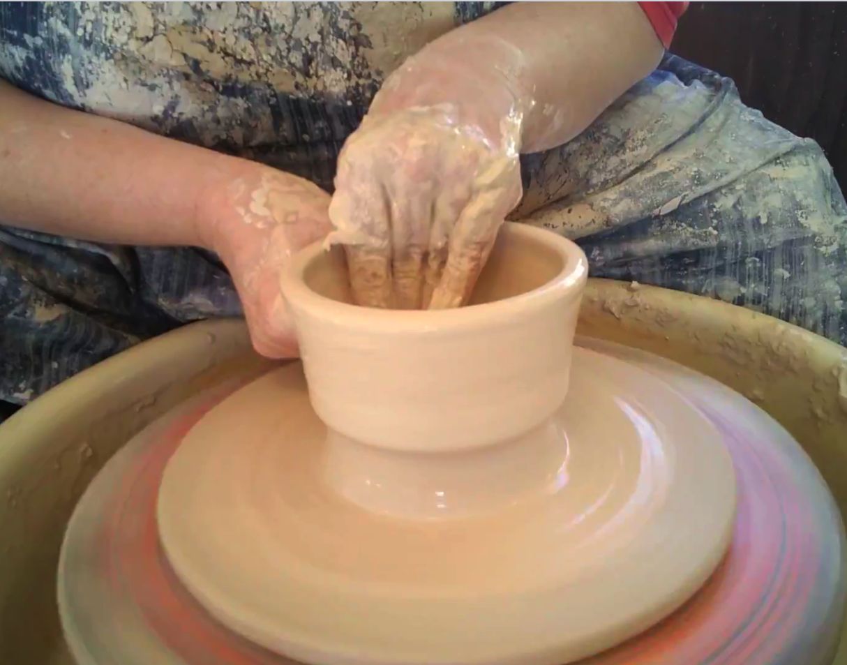 Em throwing on the wheel.